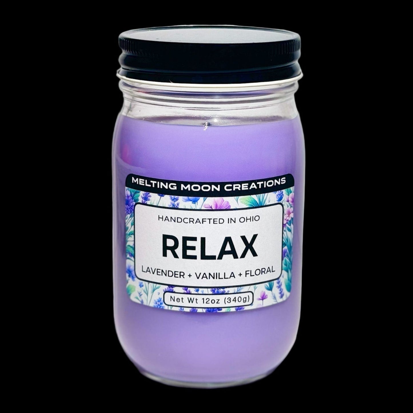 Relax candle in glass jar with black twist on lid sitting on white backdrop. Candle wax is purple. Candle label designed by Melting Moon Creations.
