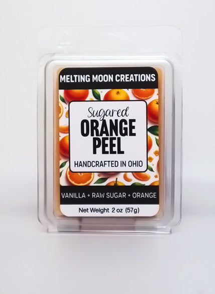 Sugared Orange Peel wax melt sitting on white backdrop. Label designed by Melting Moon Creations.