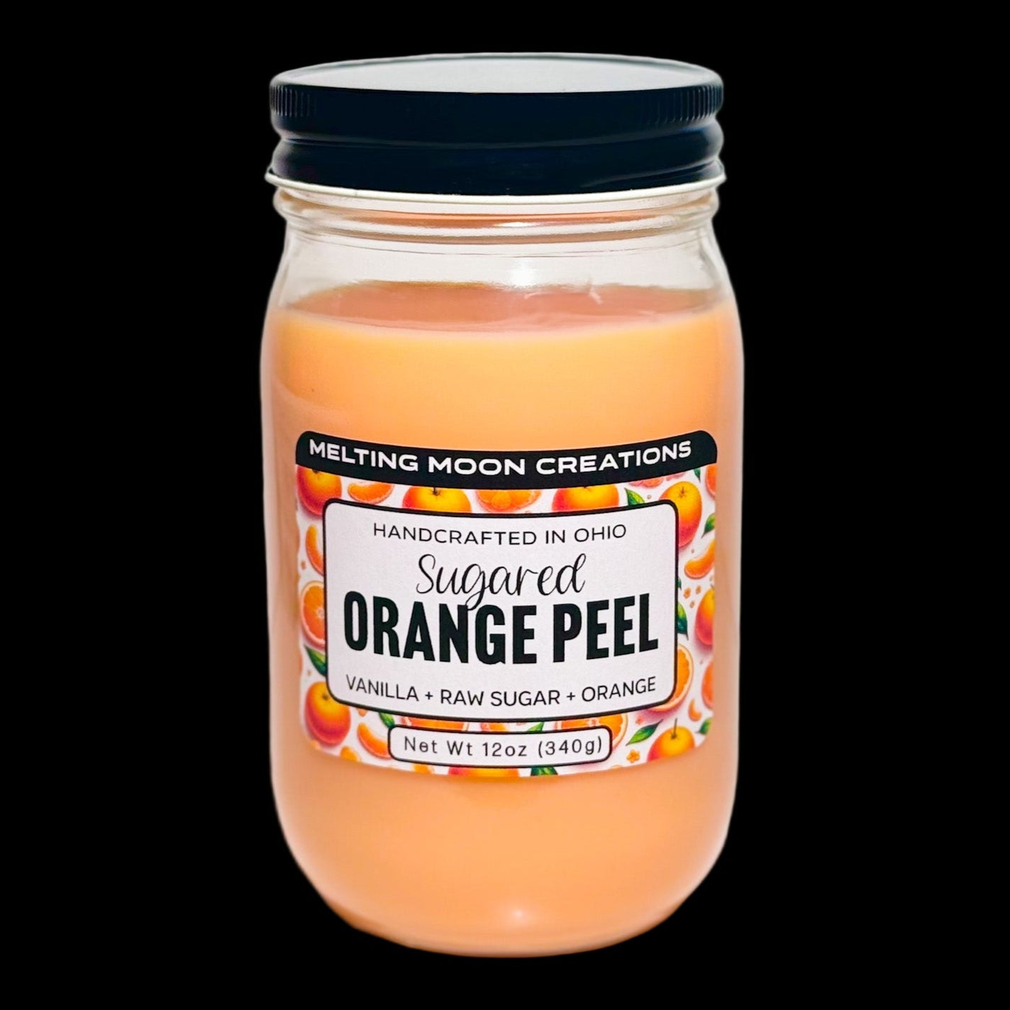 Sugared Orange Peel candle in glass jar with black screw on lid. Orange wax. Label designed by Melting Moon Creations.