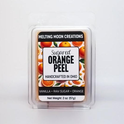 Sugared Orange Peel wax melt sitting on white backdrop. Label designed by Melting Moon Creations.