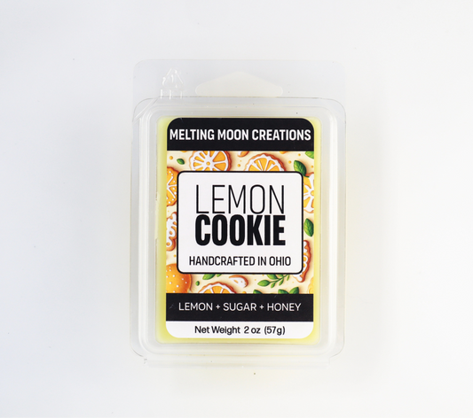 Lemon Cookie wax melt sitting on white backdrop. Labeled by Melting Moon Creations.